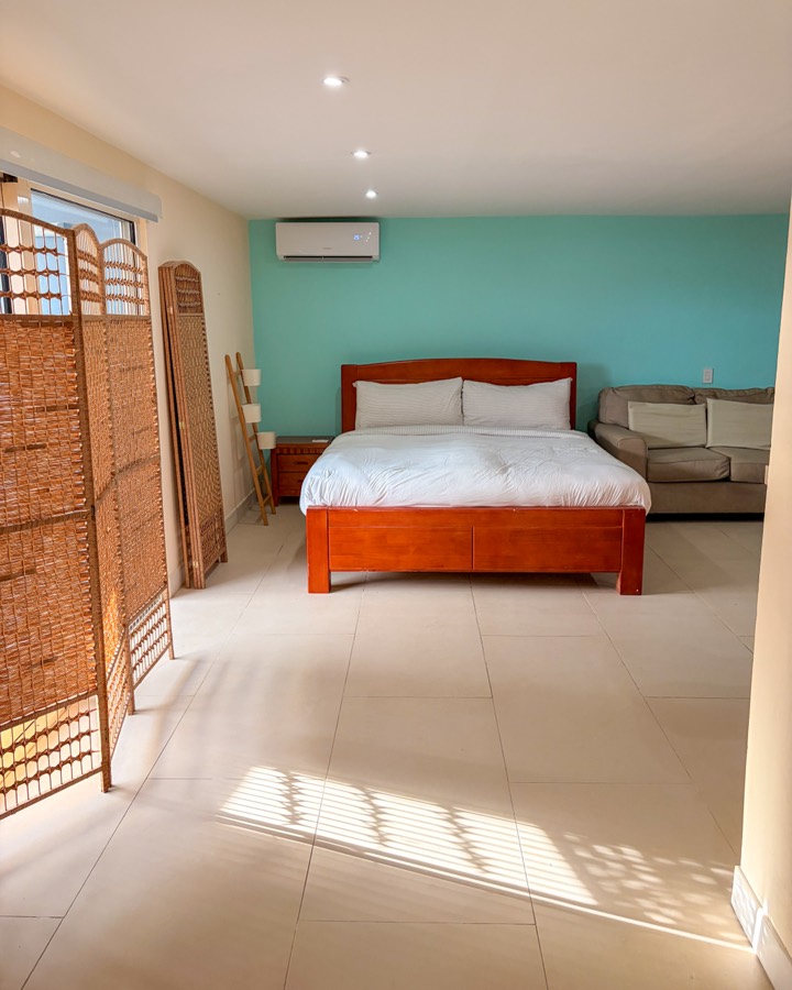 Main bedroom with a king bed and air conditioning