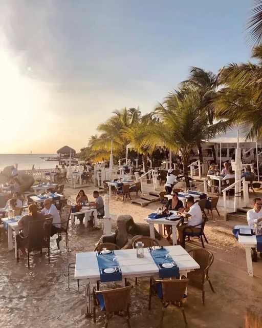Tables set in the shallow water at Flying Fishbone