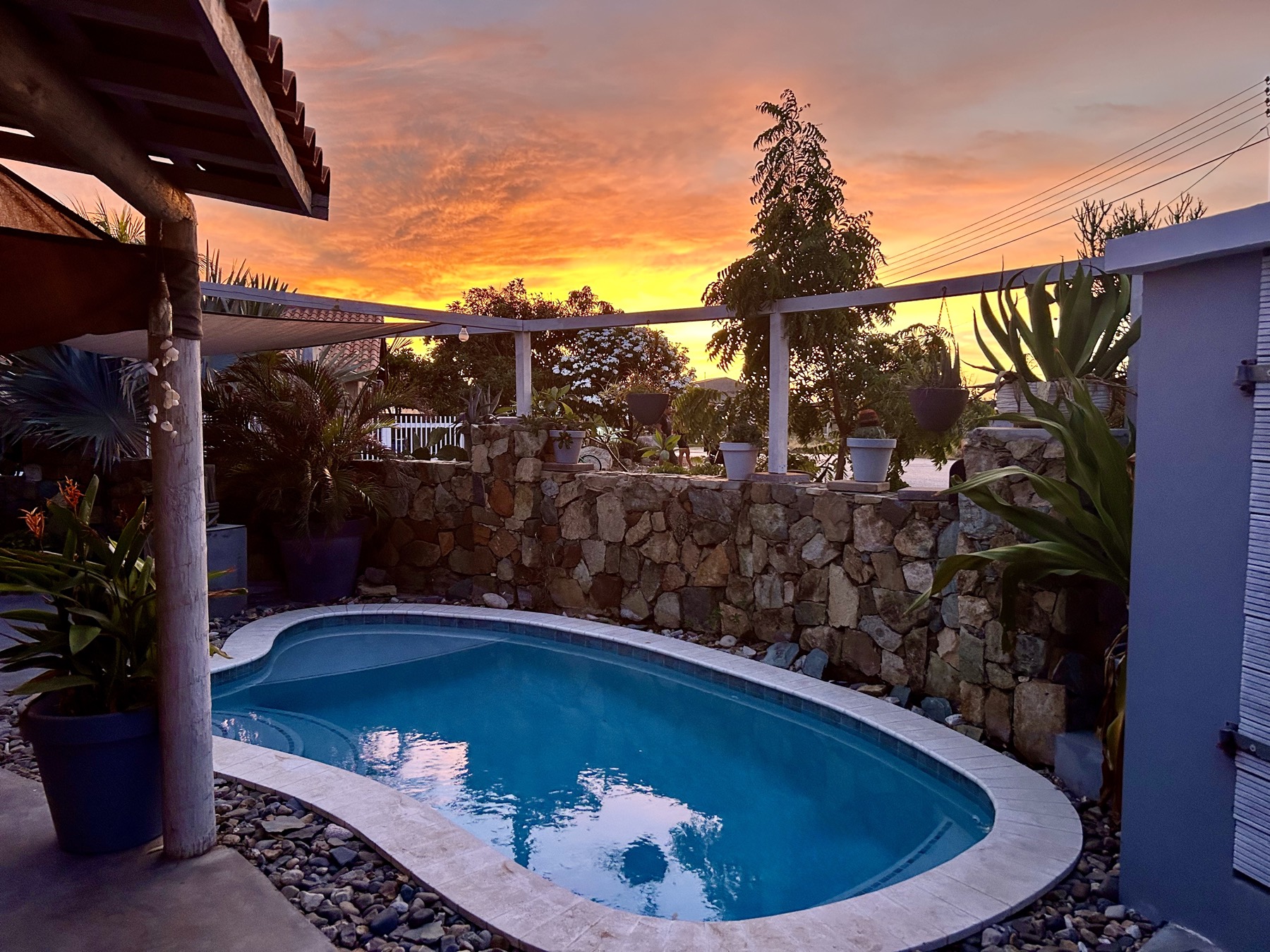 The pool at sunset under an orange sky